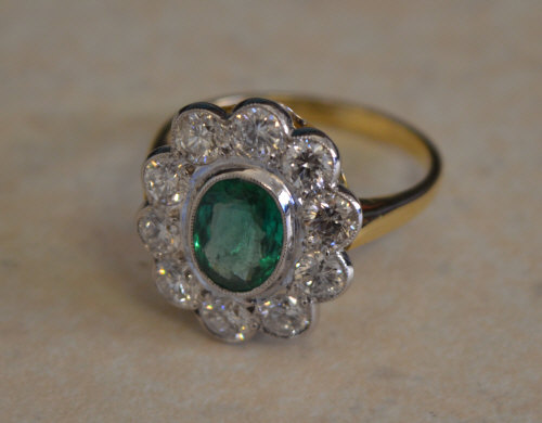 18ct gold emerald and diamond daisy ring,