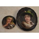 Small hand painted miniature plaque of a young girl with a dog and a similar jet mounted brooch