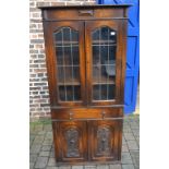 1930s oak display cabinet with carved panels