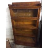 A rare & early Globe Wernicke mahogany sectional bookcase with reeded columns & stamped