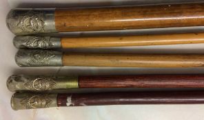 4 Lincolnshire Regiment swagger sticks & a cylinder top swagger stick