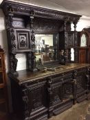 Substantial late 19th century oak sideboard with heavily carved panels & figural supports depicting