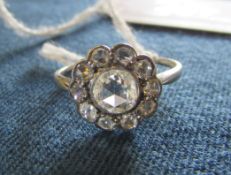 Tested as 18ct gold central rose cut diamond cluster ring with surrounding smaller diamonds,