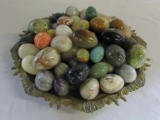 Brass tray containing quantity of mainly onyx eggs D 40 cm