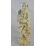 Japanese Okimono carved ivory figure approx c.1850 Meiji period, of a man with a pipe and basket.