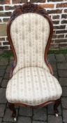 Victorian rosewood nursing chair with ornate carving on cabriole legs