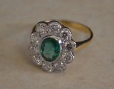 18ct gold emerald and diamond daisy ring,