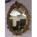 Ornate gilt framed oval wall mirror