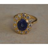 Tested as 18ct gold sapphire and diamond daisy ring,