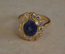 Tested as 18ct gold sapphire and diamond daisy ring,