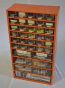Small cabinet of watchmakers parts and tools including crystals, hands,