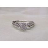 18ct white gold diamond cluster ring with baguette stones to sides (total weight 1.