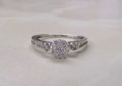 18ct white gold diamond cluster ring with baguette stones to sides (total weight 1.