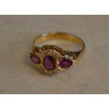Tested as 18ct gold triple ruby and diamond ring,