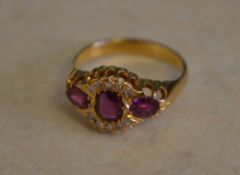 Tested as 18ct gold triple ruby and diamond ring,