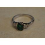 18ct white gold emerald ring flanked by baguette cut diamonds,