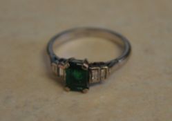 18ct white gold emerald ring flanked by baguette cut diamonds,