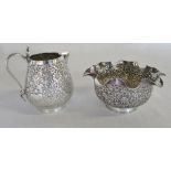 Ornate white metal jug and sugar bowl