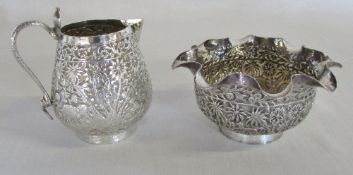 Ornate white metal jug and sugar bowl