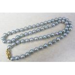 String of blue pearls with a 9ct gold clasp