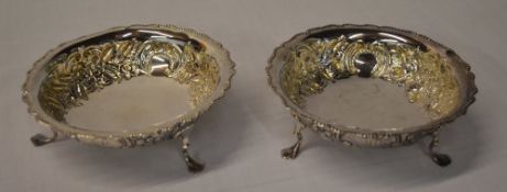 A pair of silver bonbon dishes raised on three feet,