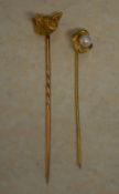 A 15ct gold fox head stick pin and a 9ct gold pearl stick pin, total approx weight 4.