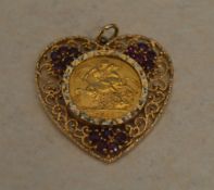 1911 22ct gold full sovereign mounted in a 9ct gold heart shaped pendant with synthetic ruby stones,