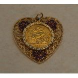 1911 22ct gold full sovereign mounted in a 9ct gold heart shaped pendant with synthetic ruby stones,