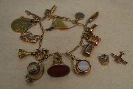A 9ct gold charm bracelet with approx 17 charms and 2 loose charms,