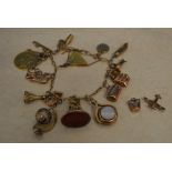 A 9ct gold charm bracelet with approx 17 charms and 2 loose charms,