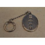 Oval silver ingot on a small silver key chain, total approx weight 1.