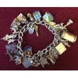Silver/white metal charm bracelet with approximately 30 silver/white metal charms total weight 2.