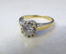 18ct gold diamond solitaire ring with diamond chip shoulders total 0.