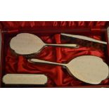 Ornate cased silver and enamel dressing table set, comprising of a hand mirror, clothes brush,