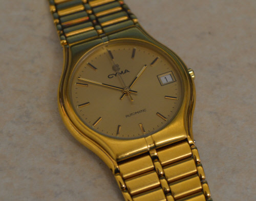 Good quality gents Cyma yellow metal automatic wristwatch with date window and baton markers
