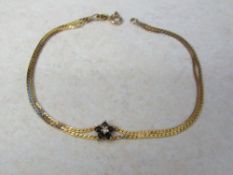 9ct gold two strand bracelet with sapphire flower total weight 2.