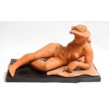 David Arnatt: a terracotta figure, reclining nude in sun hat, monogrammed, 11 1/2" high