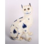 A Galle glazed earthenware model of a seated cat decorated blue hearts, 9" high (damaged and