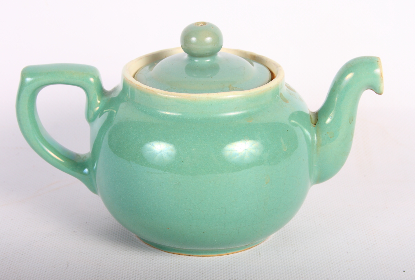 A Denby stoneware part dinner service in green and a Worcester "Evesham" teapot with side spout
