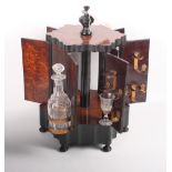 A 19th Century amboyna hexagonal drinks cabinet, base inset musical box, and a 19th Century mahogany