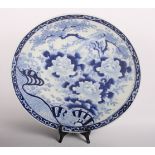 A 19th Century Chinese export blue and white porcelain charger decorated flowers, 12" wide