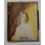 A 19th Century miniature portrait on ivory, lady with ringlets, 4" x 3", in gilt scroll decorated