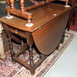 An 18th Century oak drop leaf dining table, fitted one drawer, on turned and stretchered supports