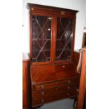 A mahogany bureau bookcase of Queen Anne design, the upper section enclosed lattice glazed doors