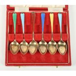 A cased set of silver gilt teaspoons with coloured enamel handles, a cased part set of mother-of-