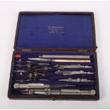 A set of late 19th Century steel drawing instruments, in fitted case, and a silver plated table