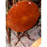 A George III mahogany circular tilt top occasional table, on cannon barrel support and tripod