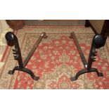 A pair of wrought iron andirons, 31" long, an ash pan and four assorted fire implements