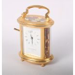 A Mappin & Webb gilded oval cased carriage clock