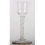 An 18th Century dwarf ale with double cotton twist stem, 5 1/2" high (chips to foot rim)